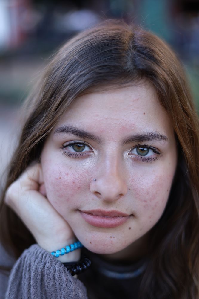 Close portrait of a woman resting her chin on her hand