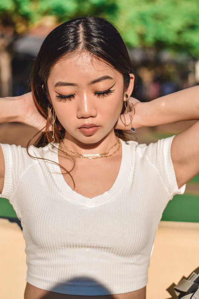Woman with her hands behind her head in warm evening light