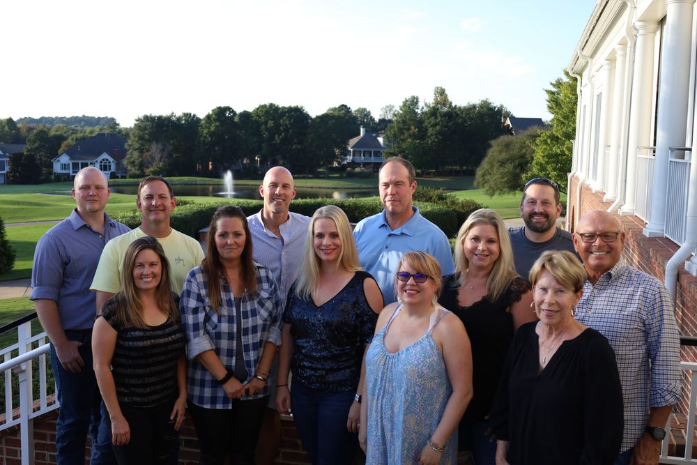 Extended family gathered on a balcony overlooking a golf course