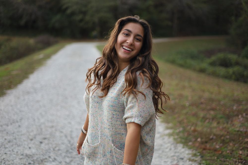 Woman laughing while walking down a gravel path