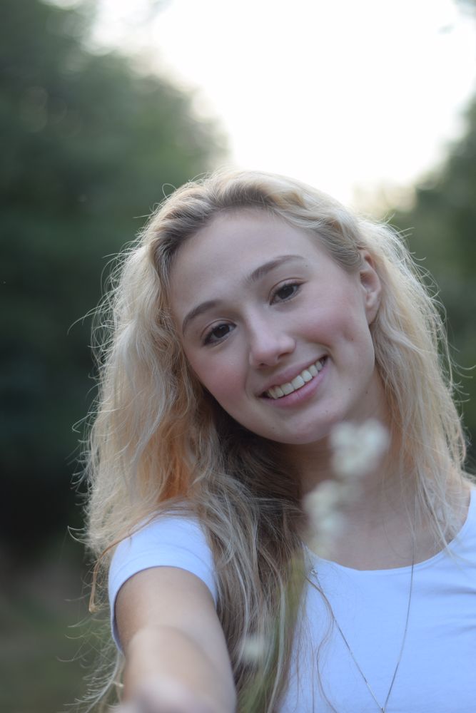 Smiling woman reaching toward the camera