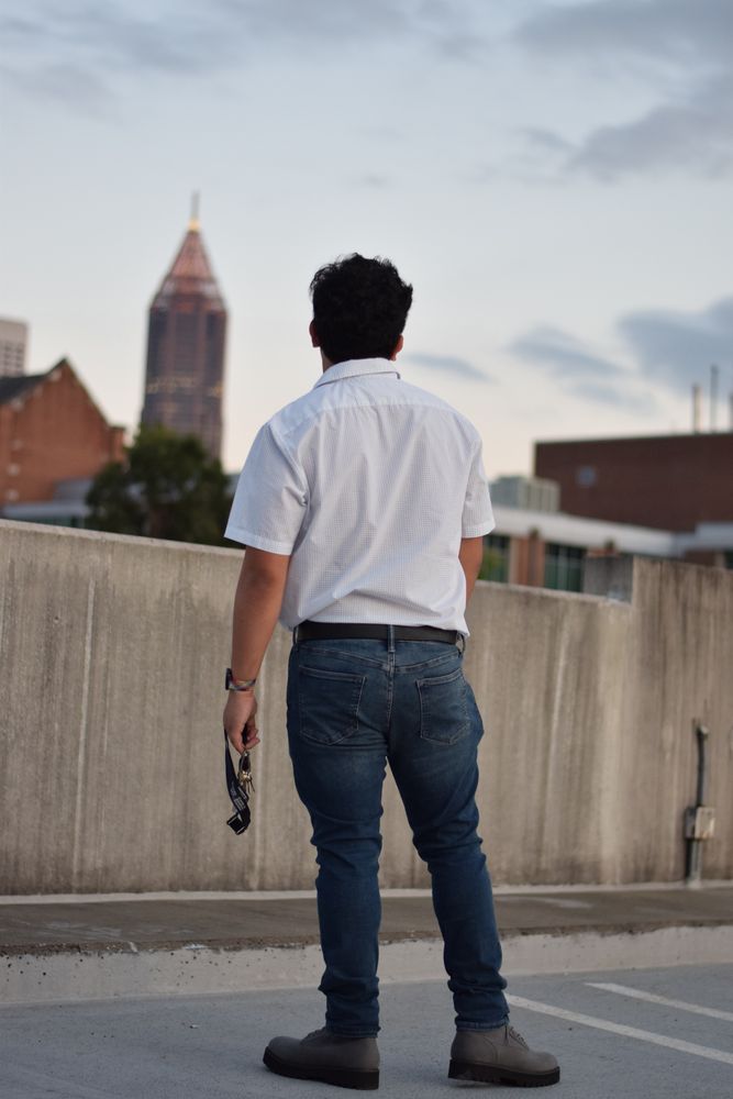 Man from behind looking out over a parking deck