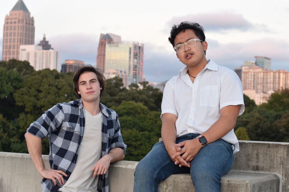 Man leaning against a concrete wall with the skyline behind