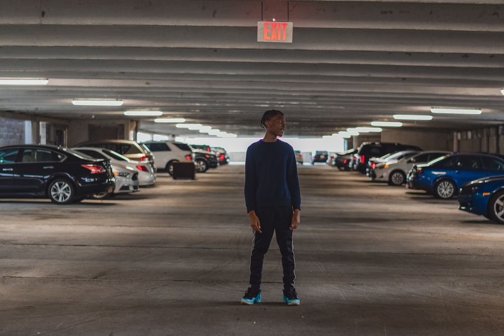 Man standing in the middle of an empty parking deck