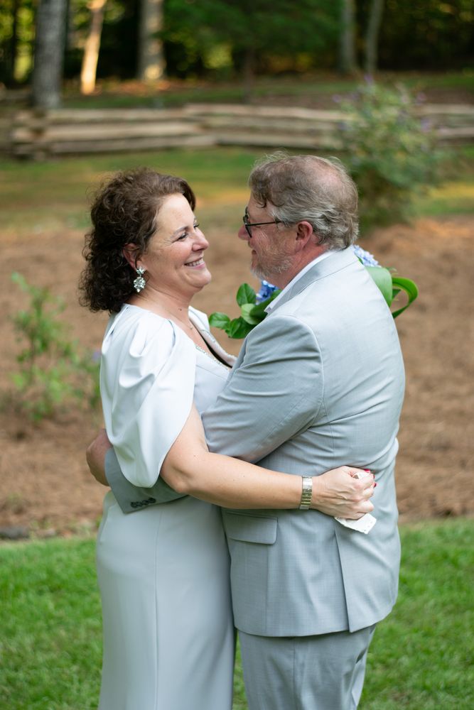 Bride and groom holding each other on the lawn